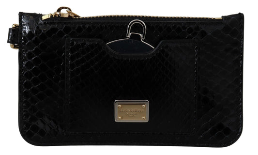 Black quilted clutch bag with gold accents on a white background