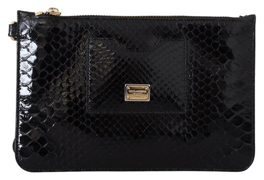 Black textured clutch bag with a gold clasp on a white background