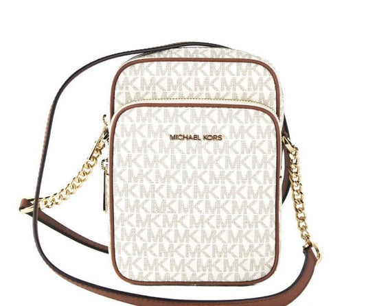 Michael Kors crossbody bag with gold chain strap on a white background
