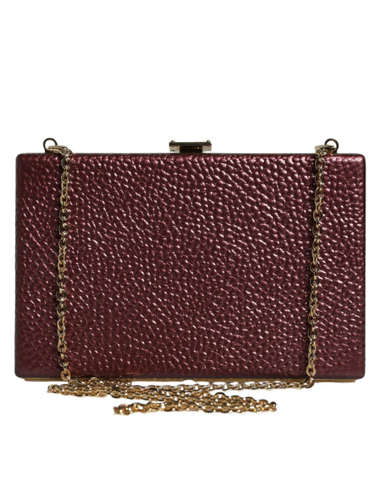 Red clutch bag with a gold chain on a white background