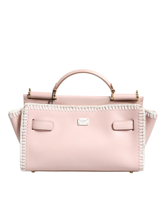 Pink handbag with decorative trim on a white background