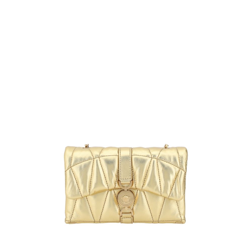 Gold quilted handbag on a white background