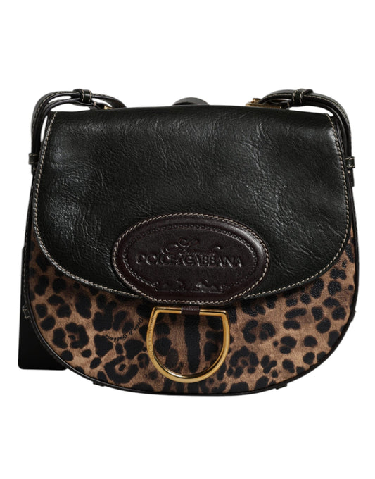 Black leather handbag with leopard print flap and gold D-ring on a white background