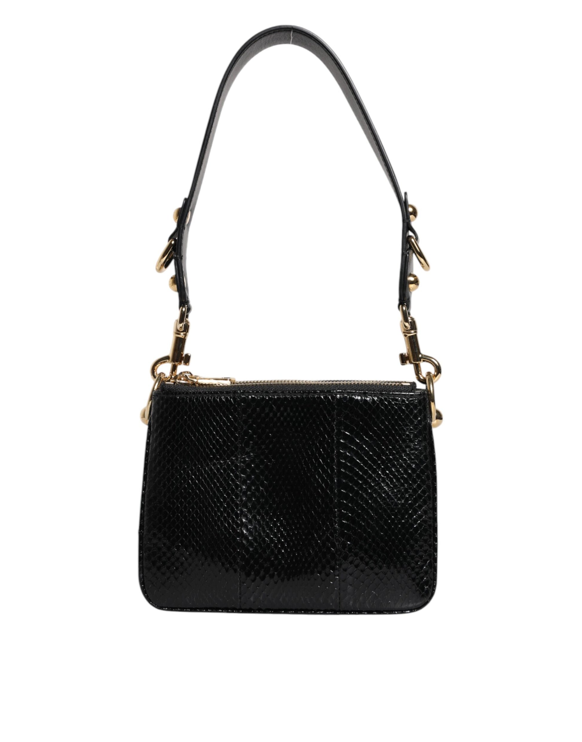 Black handbag with gold accents on a white background
