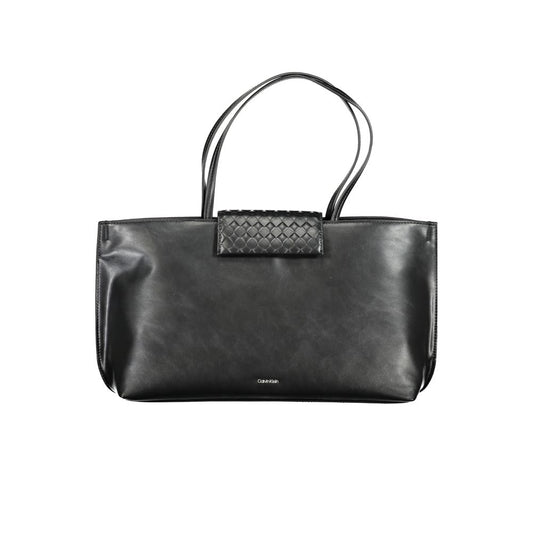 Black handbag with a textured patch on a white background
