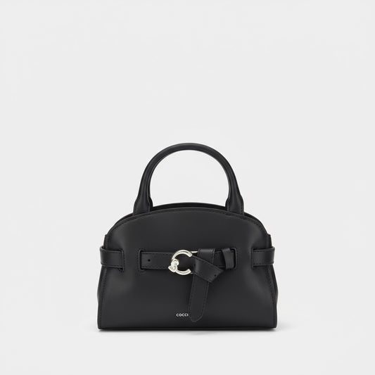 Black handbag with a decorative buckle on a white background