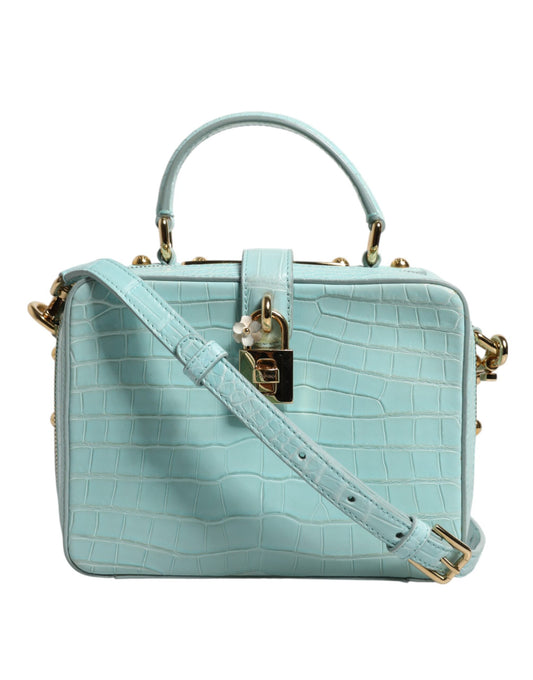 Light blue handbag with gold accents on a white background