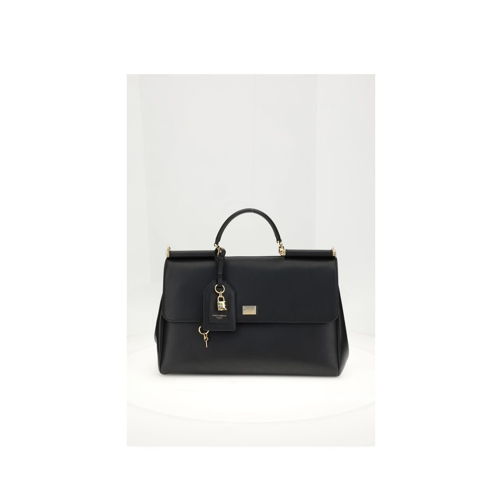 Black handbag with gold accents on a white background