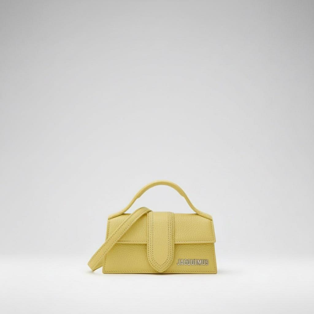 Yellow handbag with a visible brand logo on a white background