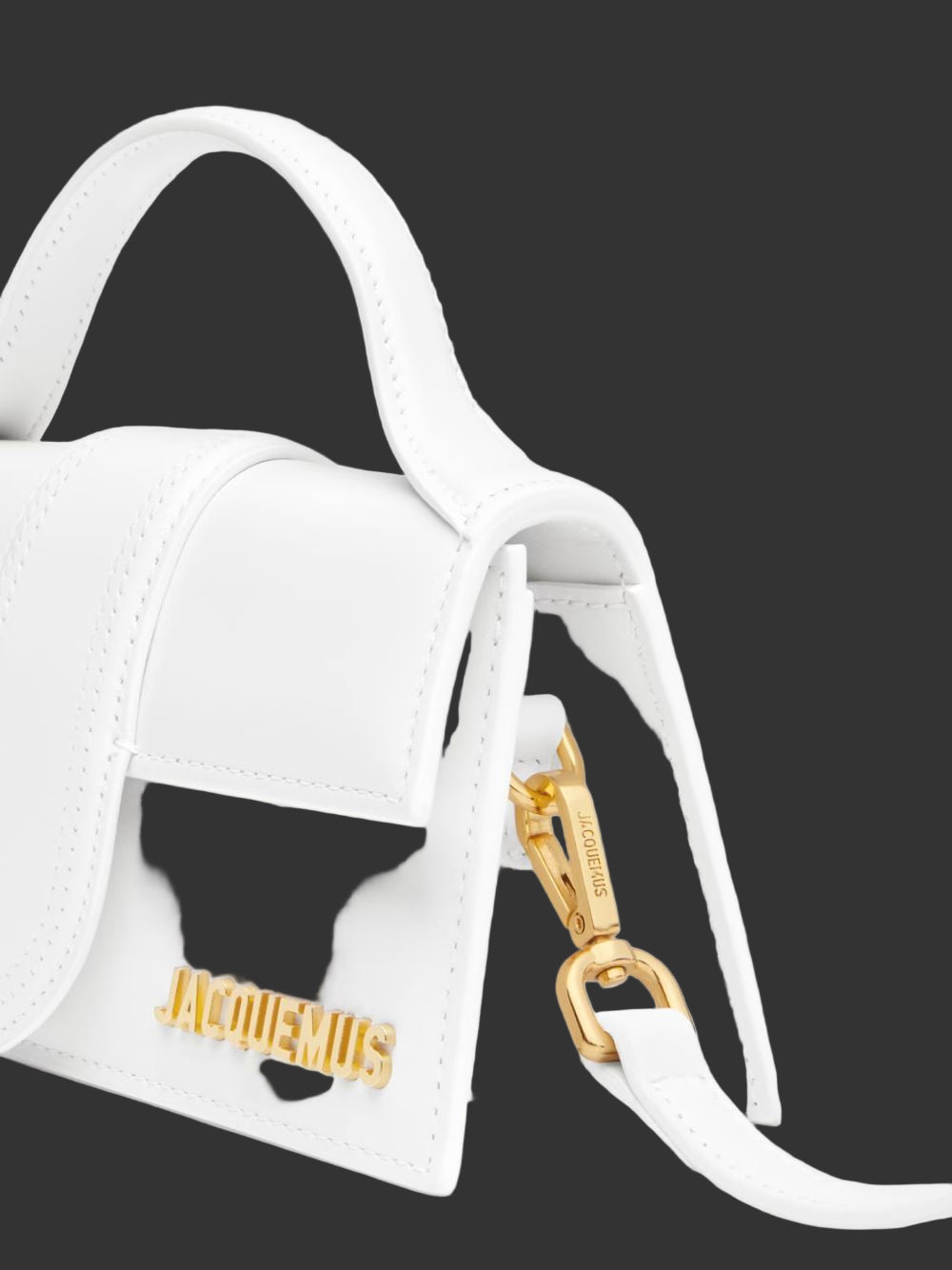 White handbag with gold clasp and 'Jacquemus' branding on a light gray background