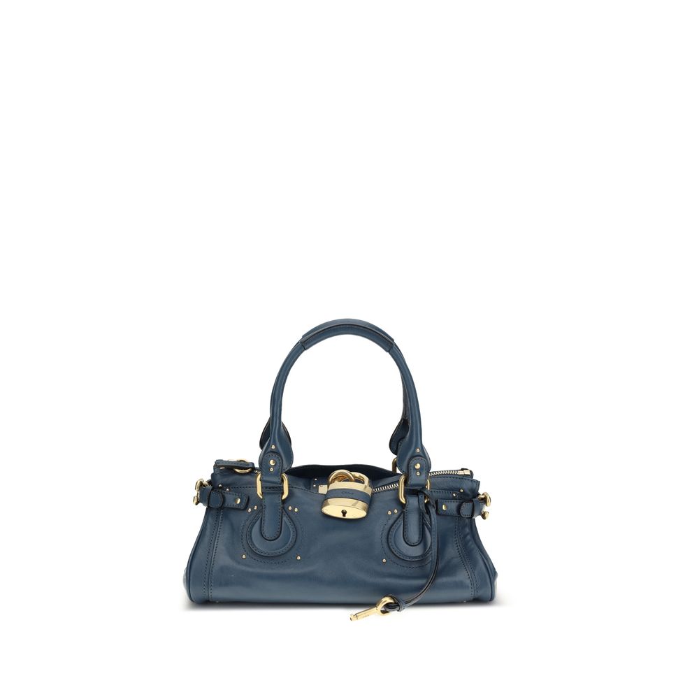Blue handbag with gold accents on a white background