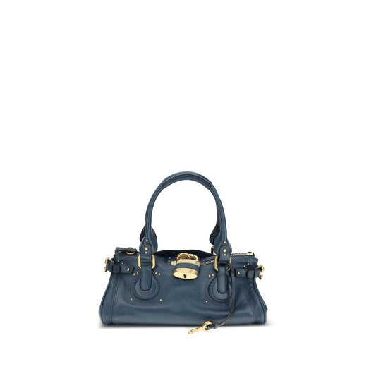 Blue handbag with gold accents on a white background